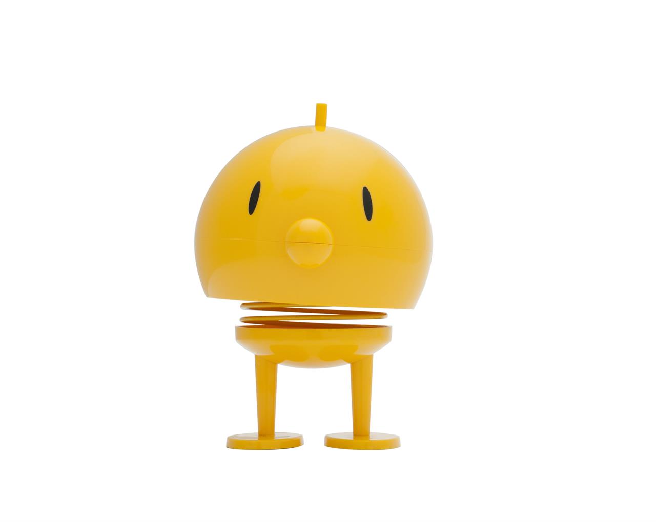 Das Bild zeigt eine gelbe Hoptimist-Figur namens Bumble. Sie hat einen runden Kopf, kleine Beine und steht auf einer Feder.