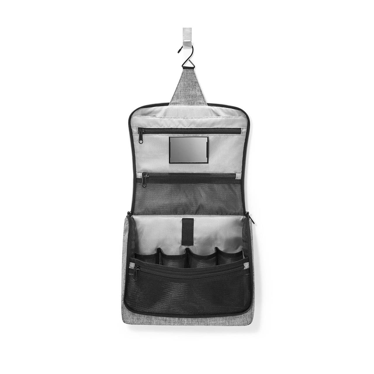 Die Abbildung zeigt eine geöffnete graue Kosmetiktasche mit mehreren Fächern und einem kleinen Spiegel. Oben befindet sich ein Haken, mit dem die Tasche aufgehängt werden kann.