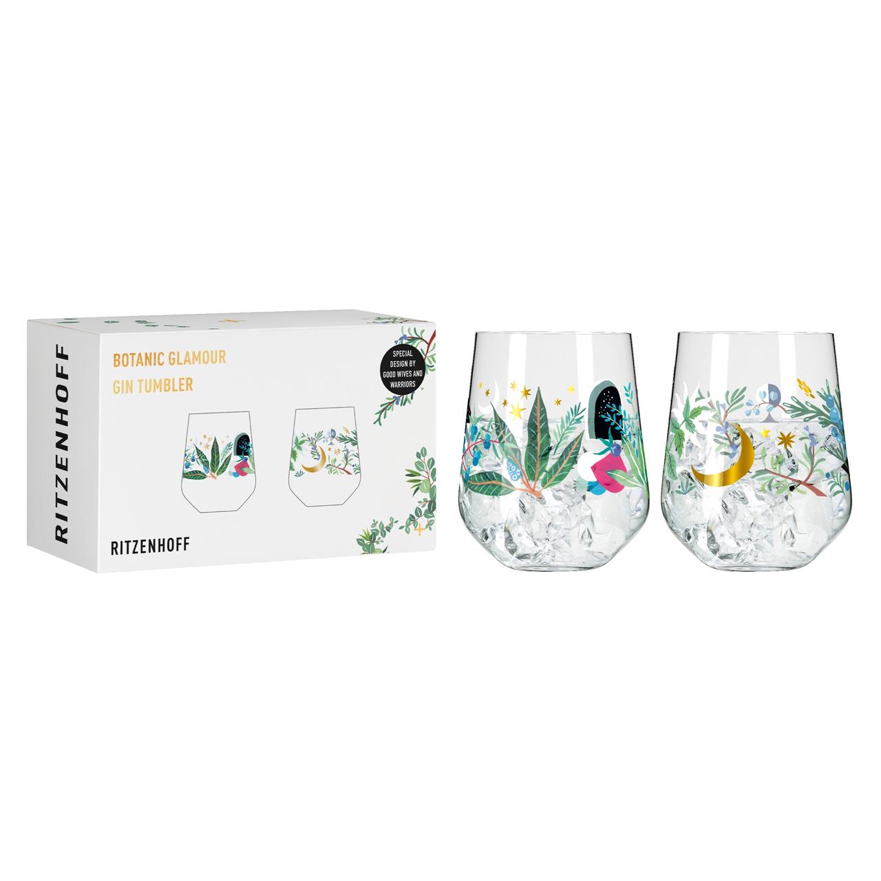Das Bild zeigt zwei dekorative Gin-Gläser mit botanischen Motiven und goldenen Details. Neben den Gläsern ist die passende Verpackung mit der Aufschrift "Botanic Glamour Gin Tumbler" zu sehen.