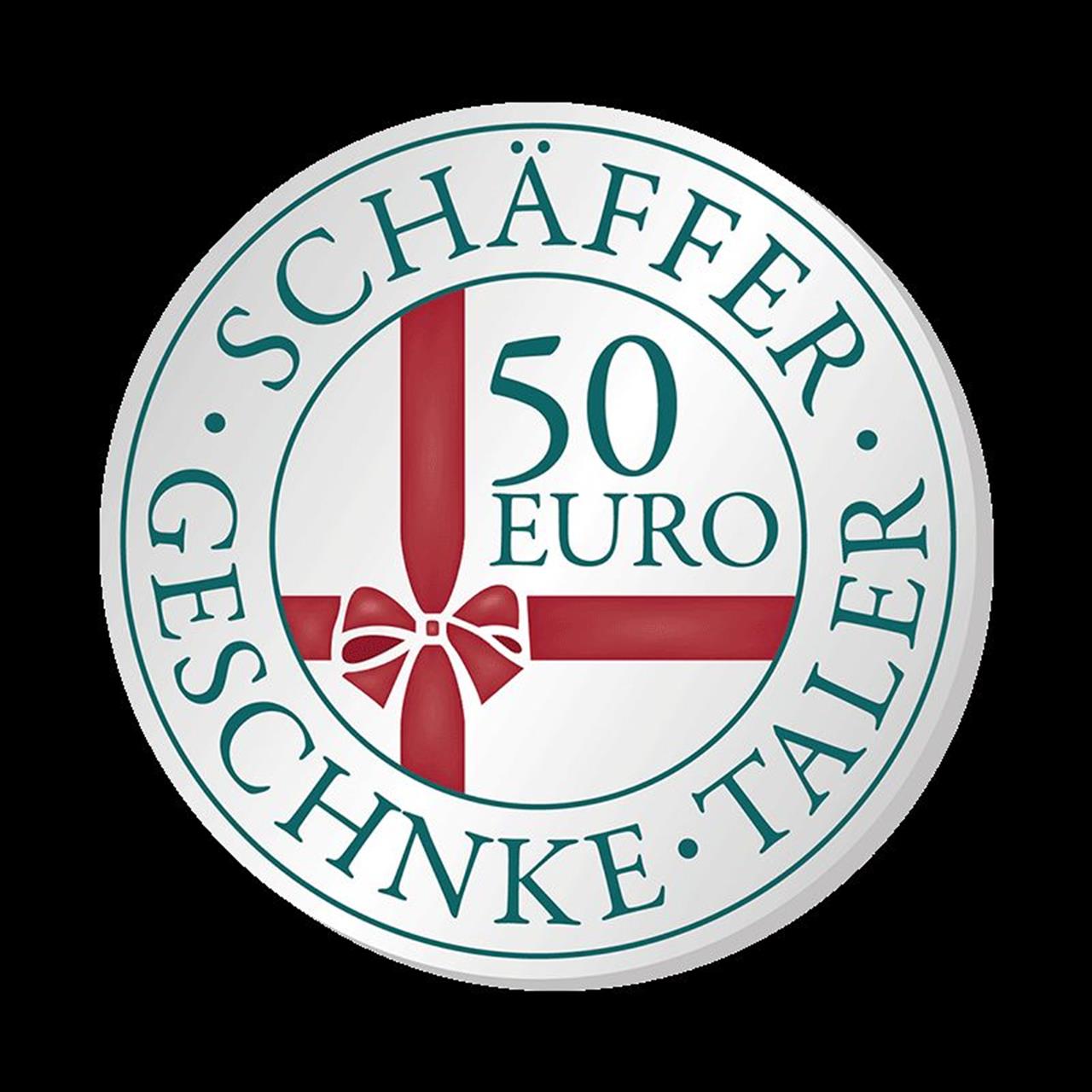 Das Bild zeigt eine runde Münze mit der Aufschrift "SCHÄFFER GESCHENKE TALER". In der Mitte steht "50 EURO" und es ist ein rotes Geschenkband mit Schleife abgebildet.