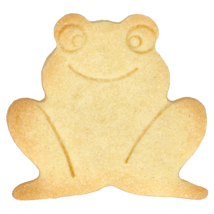 Auf dem Bild ist ein Keks in Form eines Frosches zu sehen. Der Keks zeigt durch Prägungen im Inneren ein Gesicht und Beine des Frosches.