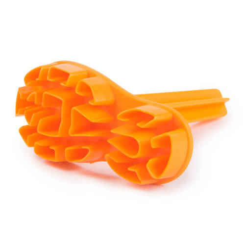 Das Bild zeigt einen orangefarbenen Kunststoffgegenstand mit mehreren abgerundeten Zacken. Er liegt auf einer weißen Oberfläche.