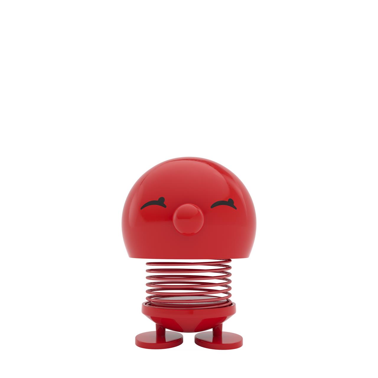 Das Bild zeigt das Produkt "Bimble M Red", eine rote, federnde Figur mit einem fröhlichen Gesicht. Es steht auf zwei runden Füßen und hat eine kugelförmige Form.