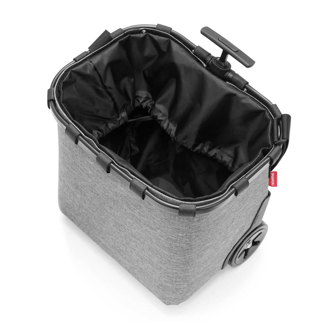 Das Bild zeigt den "carrycruiser frame twist silver", einen modernen, grauen Einkaufstrolley mit Rädern. Der Trolley hat ein großes, offenes Hauptfach mit einem schwarzen, herausziehbaren Innenfutter.