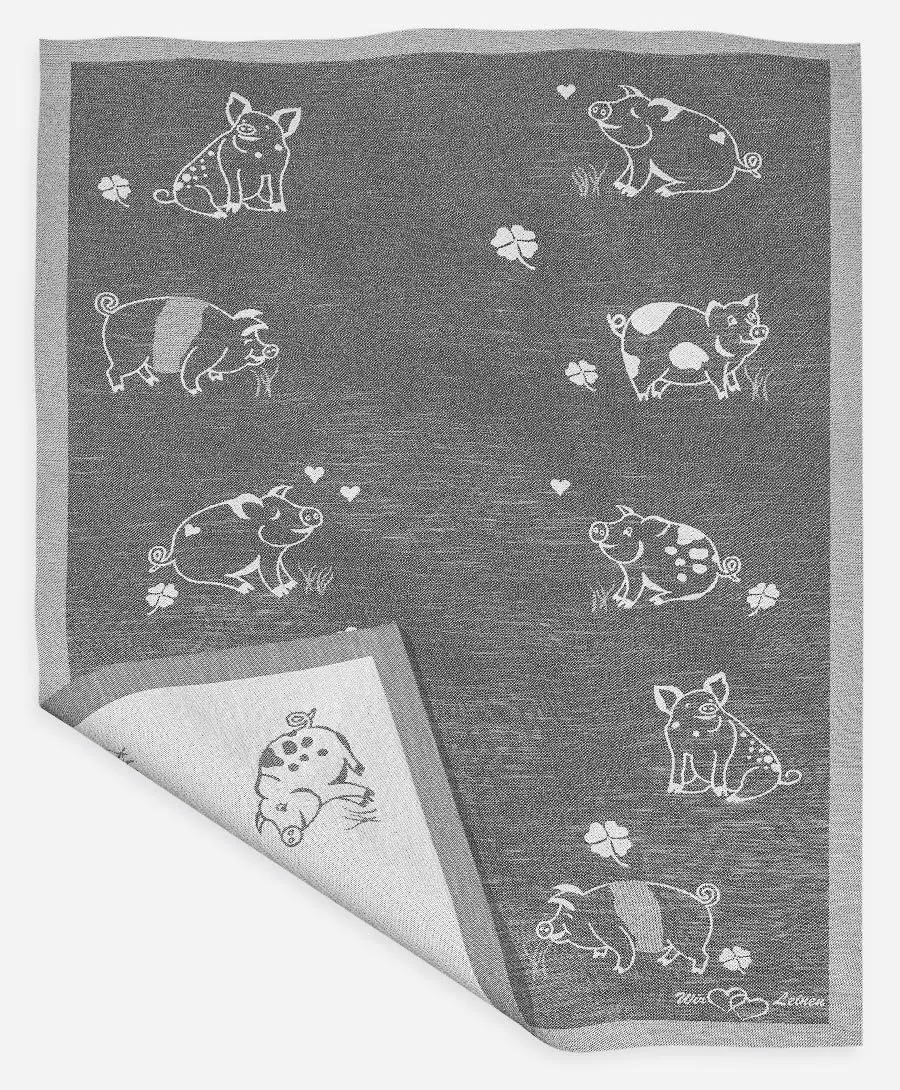 Das Bild zeigt ein schwarz-graues Geschirrtuch mit dem Namen "Eberhart" aus Halbleinen in der Größe 45x73 cm. Auf dem Tuch sind verschiedene Schweinchen und Kleeblätter abgebildet.