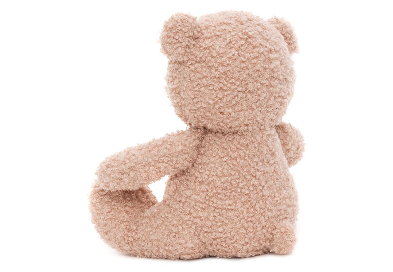 Auf dem Bild ist ein Kuscheltier in Form eines Teddybären zu sehen. Der Teddybär ist aus weichem, rosafarbenem Stoff und sitzt mit dem Rücken zur Kamera.