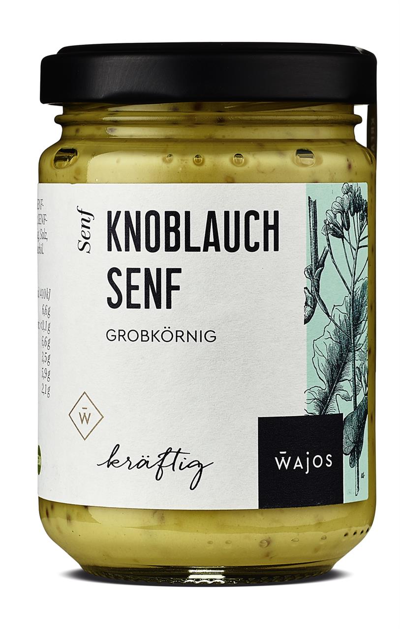 Das Bild zeigt ein Glas Knoblauch Senf der Marke Wajos mit einem Fassungsvermögen von 140 ml. Das Etikett beschreibt den Senf als grobkörnig und kräftig.