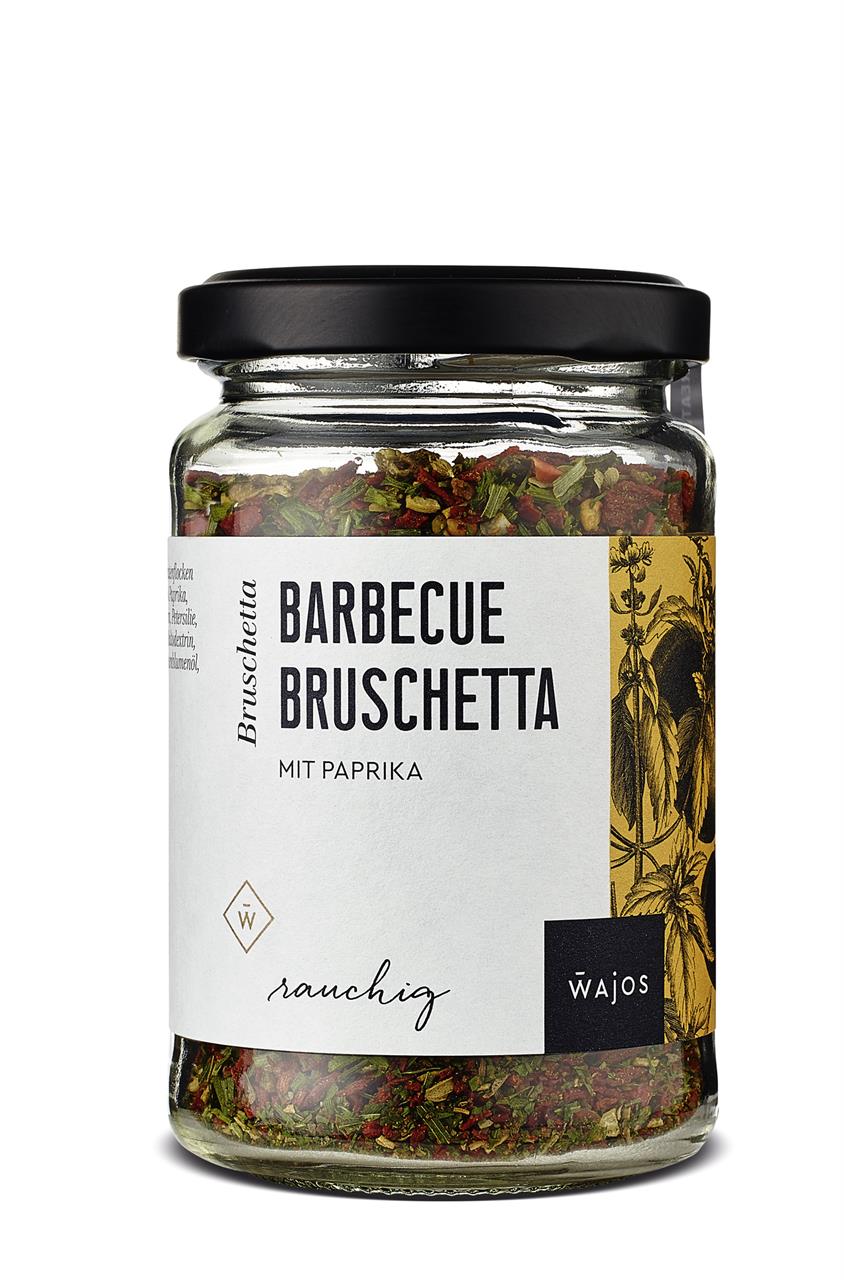 Das Bild zeigt ein Glas mit der Gewürzmischung "Barbecue Bruschetta mit Paprika" von Wajos. Die Gewürzmischung ist in einem transparenten Glas mit schwarzem Deckel abgefüllt.