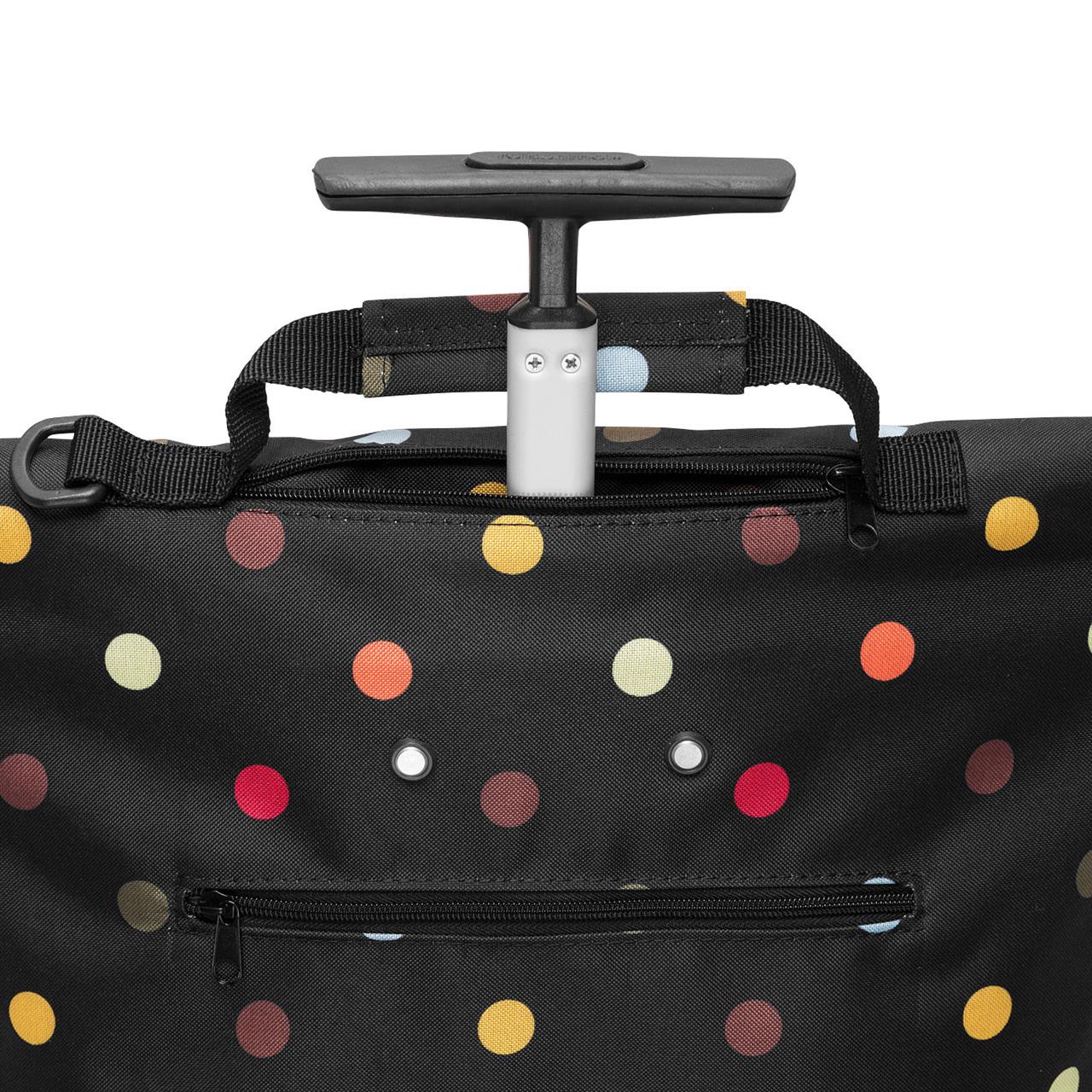 Die Abbildung zeigt eine schwarze Trolley-Tasche mit bunten Punkten und einer ausziehbaren Griffstange. Vorne befindet sich ein Fach mit Reißverschluss für zusätzlichen Stauraum.