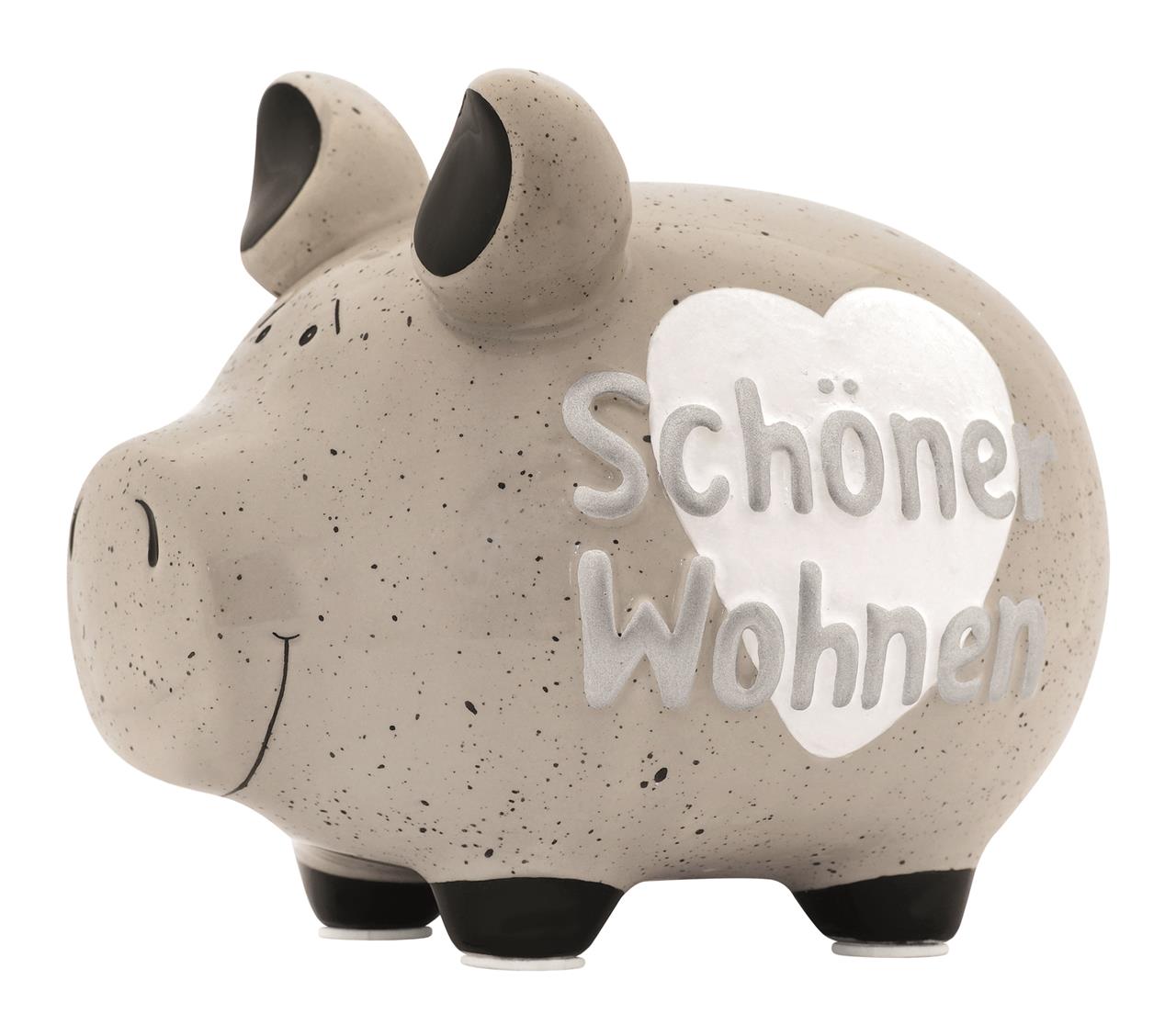 Das Bild zeigt ein helles Sparschwein mit schwarzen Punkten und schwarzen Füßen. Auf der Seite steht in einem weißen Herz der Schriftzug "Schöner Wohnen".