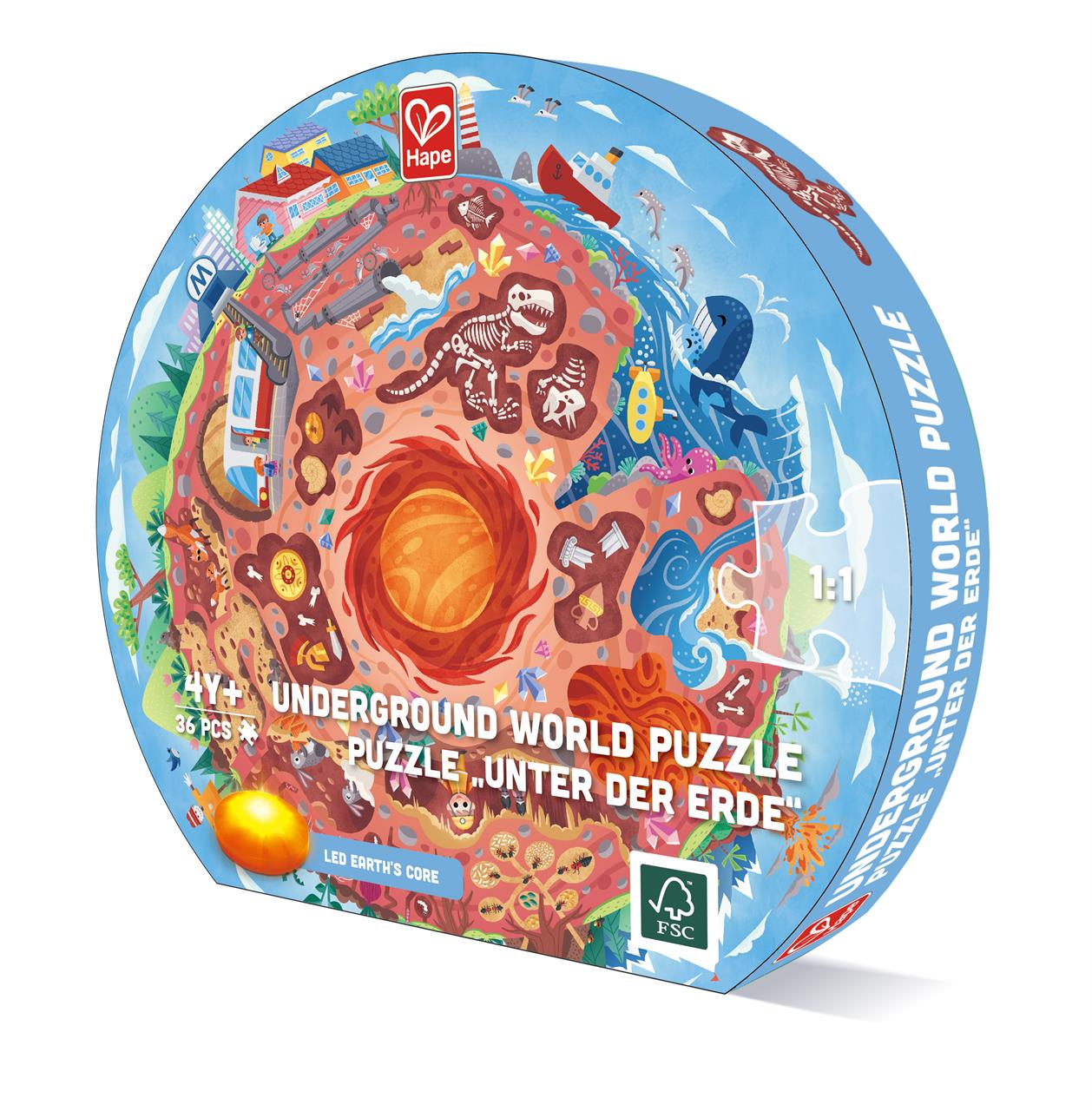 Auf dem Bild ist die Verpackung des Puzzles „Unter der Erde“ mit 36 Teilen zu sehen. Die Verpackung zeigt eine bunte, kreisförmige Illustration von verschiedenen Schichten unter der Erde, inklusive Dinosaurierknochen und Erdschichten.