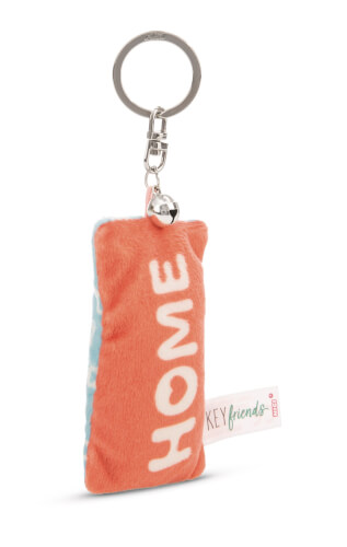 Auf dem Bild ist ein Plüsch-Schlüsselanhänger in orange mit der Aufschrift "HOME" zu sehen. An dem Anhänger ist ein Metallring und ein kleines Glöckchen befestigt.