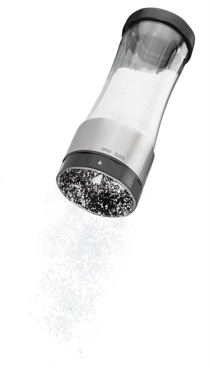 Auf dem Bild ist die Puderzuckermühle Dispenso zu sehen. Aus der Mühle rieselt Puderzucker auf eine weiße Fläche.