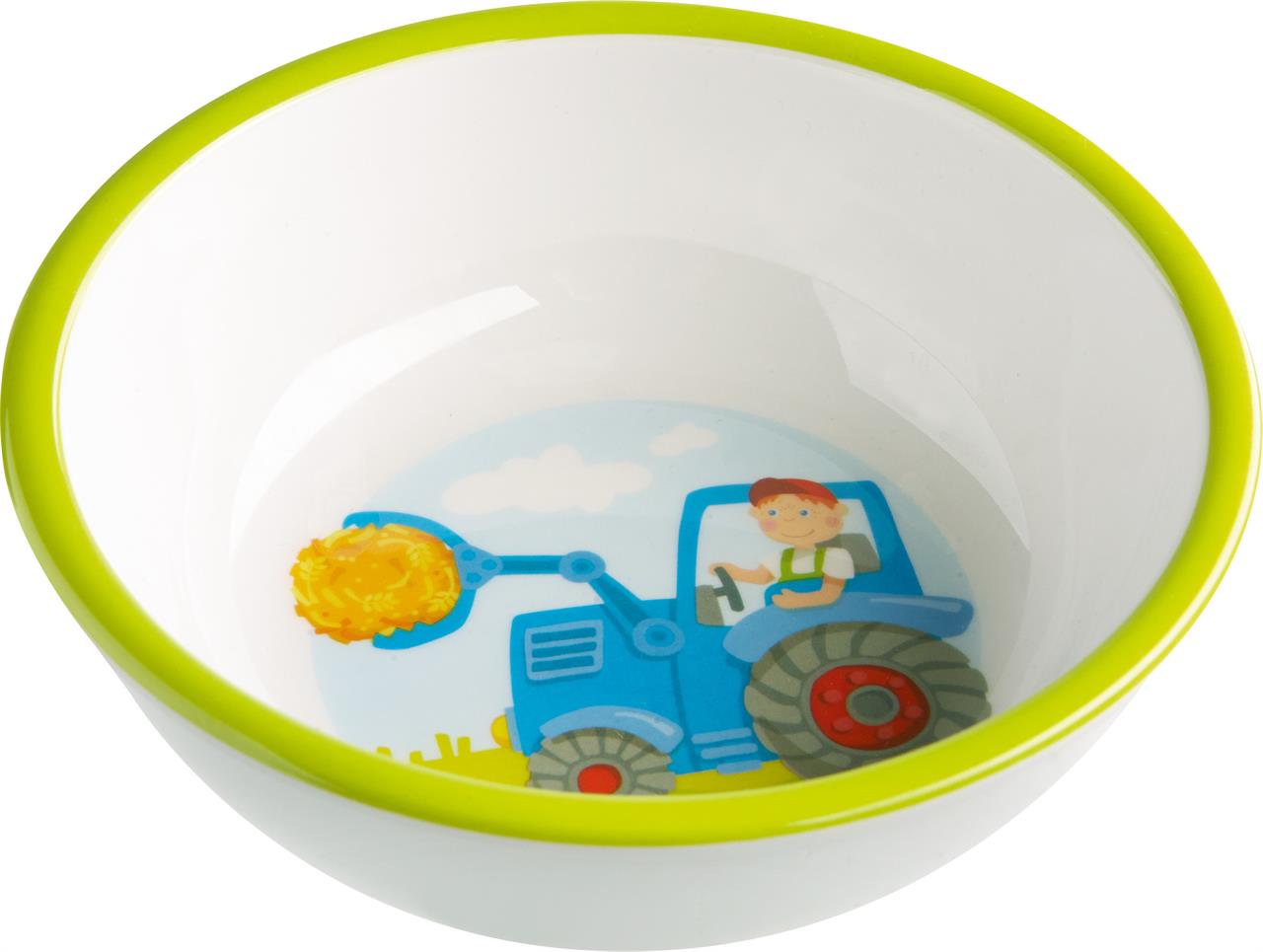 Die Schüssel zeigt ein buntes Bild von einem Traktor mit einem fröhlichen Fahrer. Der Rand der Schüssel ist grün umrandet.