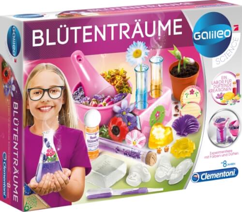 Auf dem Bild ist ein Experimentierkasten mit dem Namen "Blütenträume" zu sehen. Ein lächelndes Mädchen hält stolz ein Reagenzglas mit bunten Blumen, und verschiedene Bastelmaterialien sind abgebildet.
