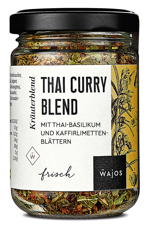 Das Bild zeigt ein Glas mit der Aufschrift "Thai Curry Blend" von Wajos. Die Gewürzmischung enthält Thai-Basilikum und Kaffirlimettenblätter.