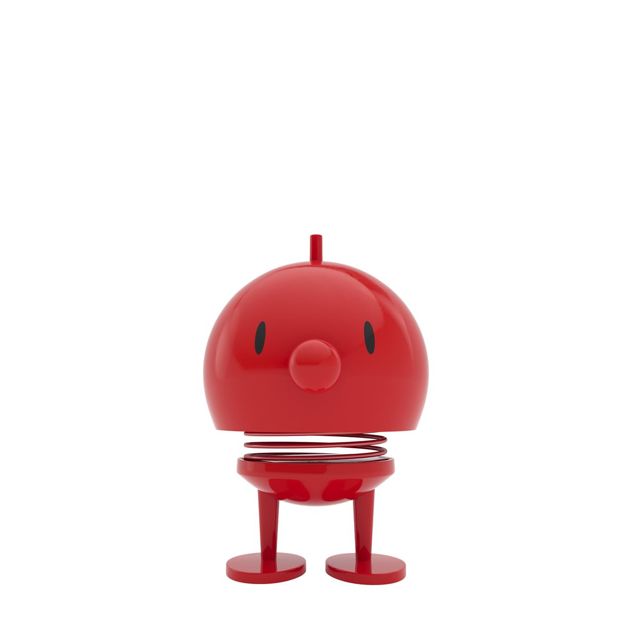 Auf dem Bild ist der Hoptimist Bumble M in Rot zu sehen. Die Figur hat einen runden Kopf, einen kleinen Schnabel und steht auf zwei Beinen mit einer sichtbaren Feder in der Mitte.