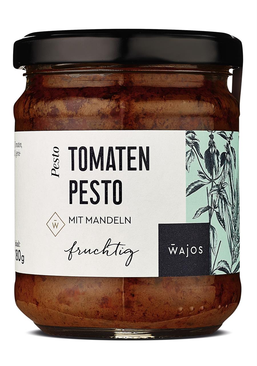 Das Bild zeigt ein Glas Tomaten Pesto mit Mandeln von der Marke Wajos. Das Glas enthält 180 Gramm würzige Sauce.