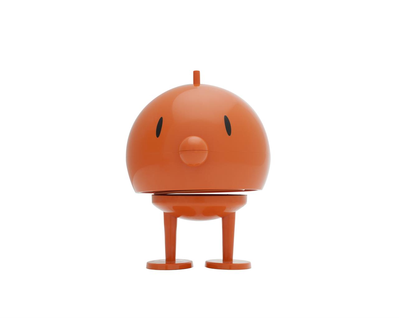 Das Bild zeigt das Produkt "Bumble L Orange". Es ist eine orangefarbene, rundliche Figur mit zwei Beinen und einem kleinen Punkt als Nase.
