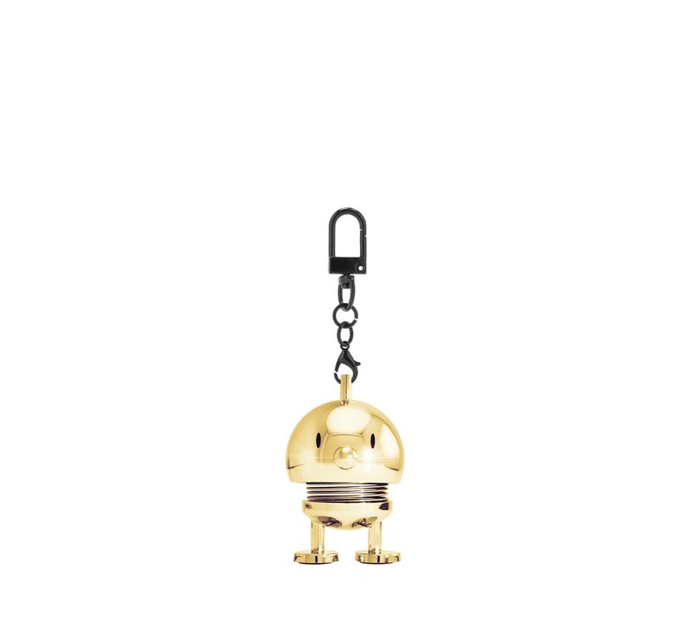 Der Hoptimist Bag Charm in Gold ist ein dekorativer Anhänger. Er eignet sich ideal als modisches Accessoire für Taschen.