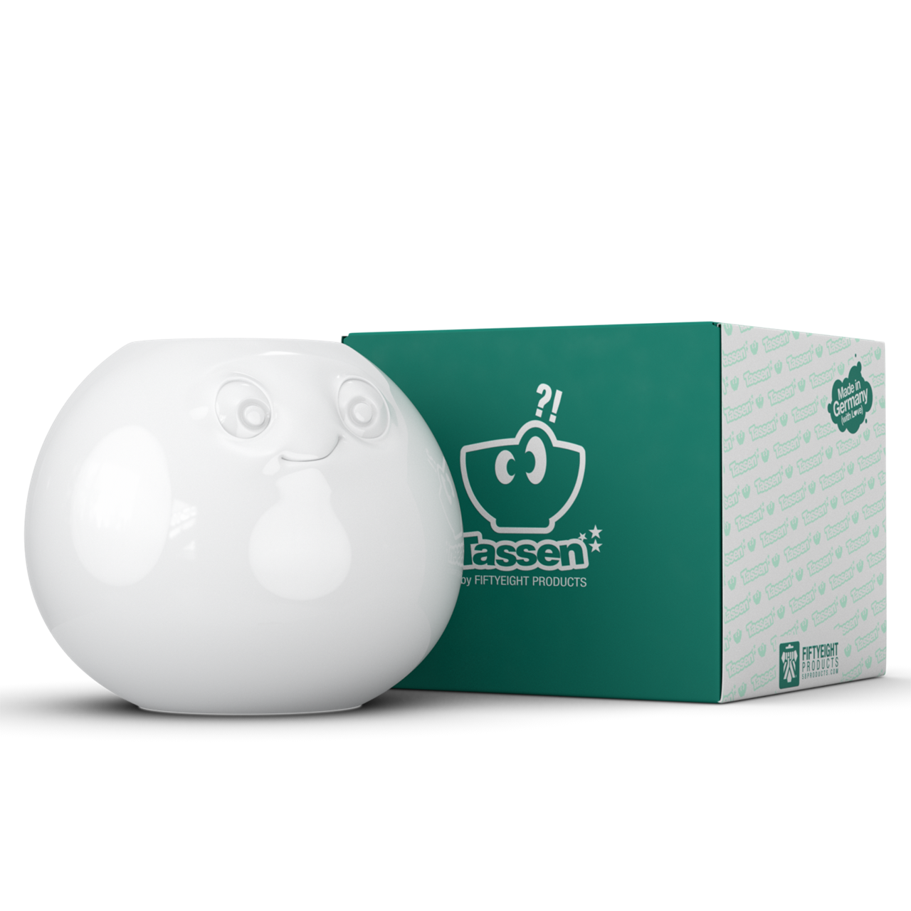 Die Abbildung zeigt die Vase "Amüsiert weiß" mit einem fröhlichen Gesichtsausdruck. Neben der Vase steht die passende grüne Verpackungsbox der Marke Tassen.