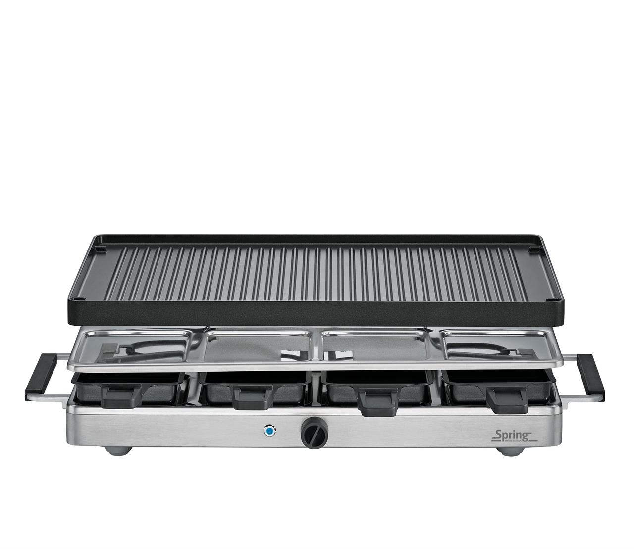 Das Bild zeigt ein Raclette-Gerät mit einer geriffelten Aluminium-Grillplatte. Es hat mehrere kleine Pfännchen und einen Temperaturregler an der Vorderseite.