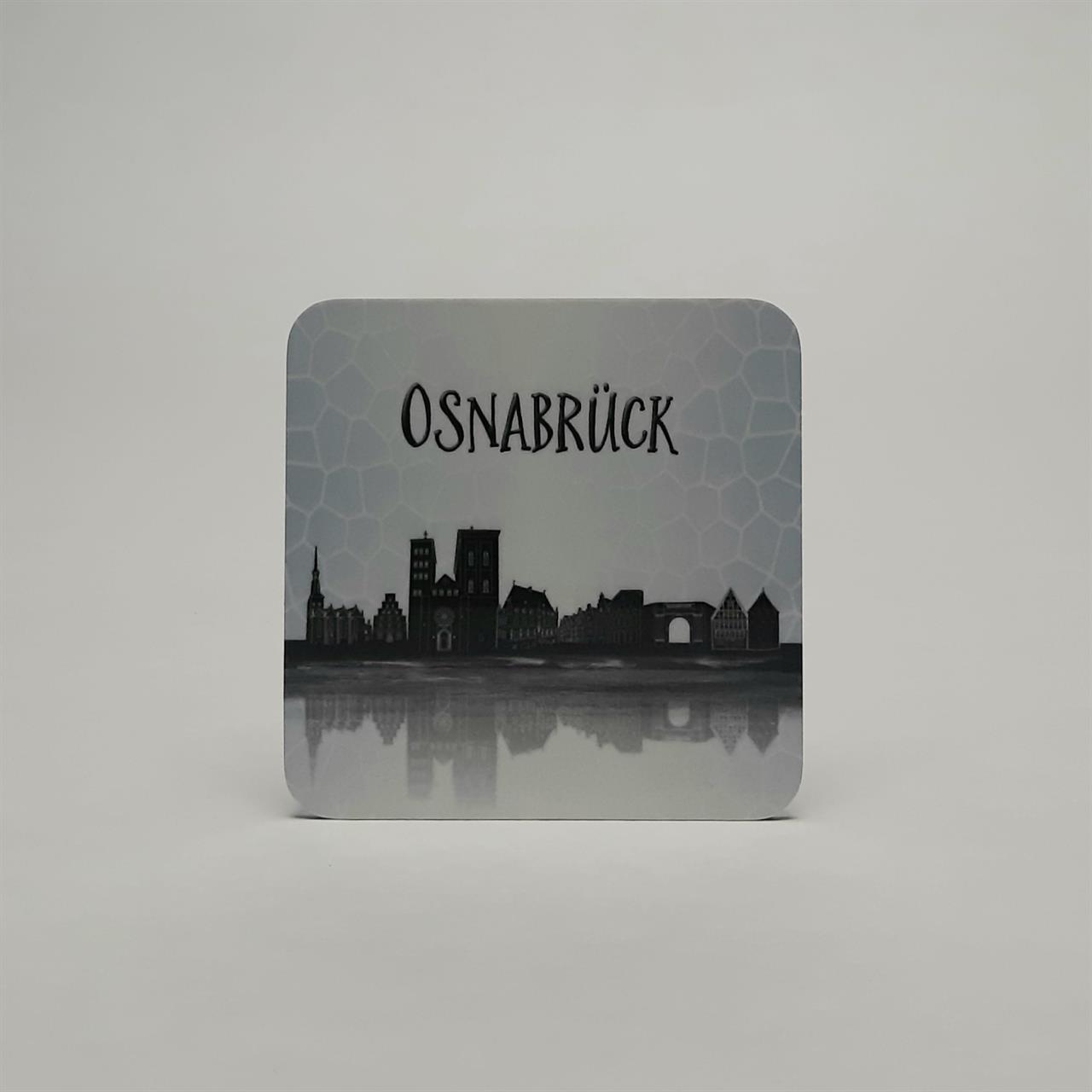 Das Bild zeigt einen Untersetzer mit der gespiegelten Skyline von Osnabrück. Oben steht in großen Buchstaben "Osnabrück".