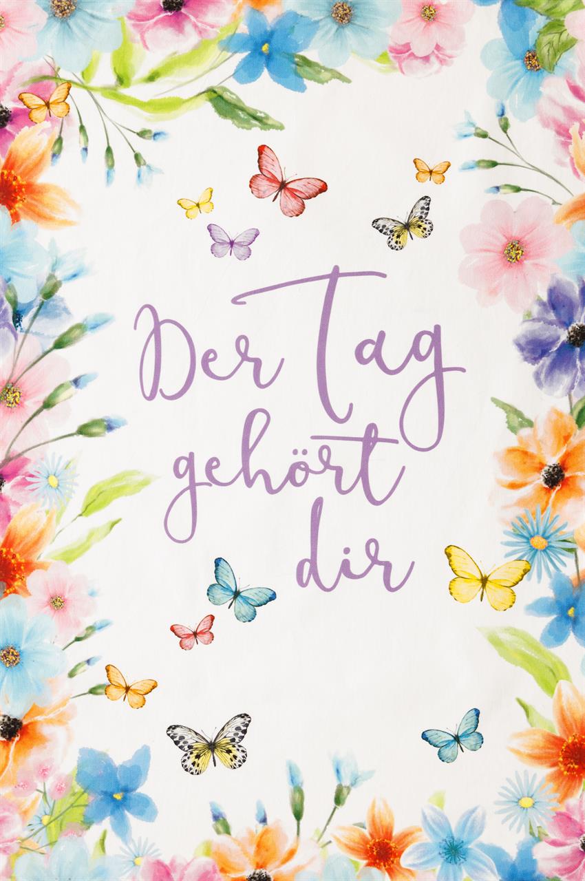 Das Bild zeigt ein Geschirrtuch mit bunten Blumen und Schmetterlingen am Rand. In der Mitte steht der Spruch "Der Tag gehört dir" in lila Schrift.