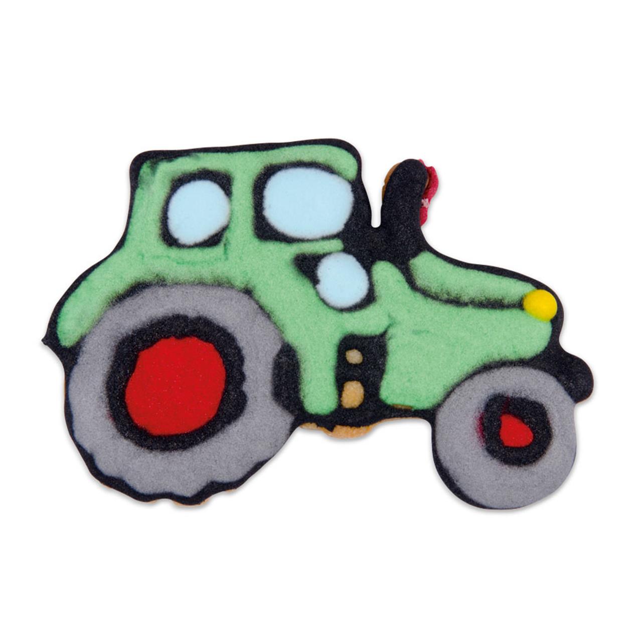Das Bild zeigt einen Ausstecher in Form eines Traktors, der etwa 7,5 cm groß ist. Der Traktor ist bunt gestaltet, hauptsächlich in Grün, Grau und Rot.